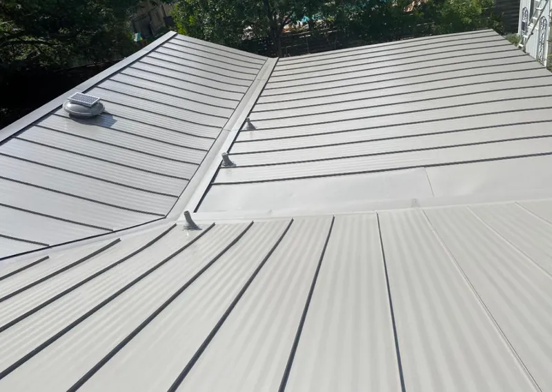 Solar attic fan installed on a metal roof for Roof Ventilation in Royal Palm Beach