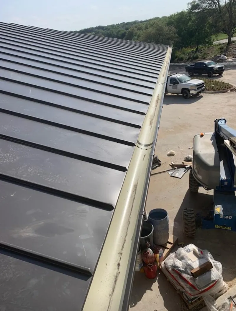 Standing seam panel and gutter detail on a metal roofing jobsite in Royal Palm Beach